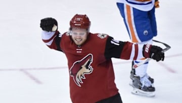 Jan 12, 2016; Glendale, AZ, USA; Arizona Coyotes center Max Domi (16) celebrates after scoring a goal for his first NHL hat trick during the third period against the Edmonton Oilers at Gila River Arena. Mandatory Credit: Matt Kartozian-USA TODAY Sports