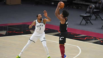 CLEVELAND, OHIO - JANUARY 20: Collin Sexton #2 of the Cleveland Cavaliers shoots over Kevin Durant #7 of the Brooklyn Nets during double overtime at Rocket Mortgage Fieldhouse on January 20, 2021 in Cleveland, Ohio. The Cavaliers defeated the Brooklyn Nets 147-135 in double overtime. NOTE TO USER: User expressly acknowledges and agrees that, by downloading and/or using this photograph, user is consenting to the terms and conditions of the Getty Images License Agreement. (Photo by Jason Miller/Getty Images)