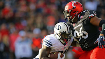 BYU Cougars running back Jamaal Williams is tackled by Cincinnati Bearcats defensive tackle Cortez Broughton at Nippert Stadium. USA Today.