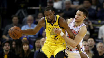 OAKLAND, CALIFORNIA - JANUARY 08: Kevin Durant #35 of the Golden State Warriors is guarded by Kevin Knox #20 of the New York Knicks at ORACLE Arena on January 08, 2019 in Oakland, California. NOTE TO USER: User expressly acknowledges and agrees that, by downloading and or using this photograph, User is consenting to the terms and conditions of the Getty Images License Agreement. (Photo by Ezra Shaw/Getty Images)