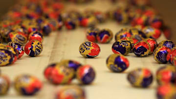BIRMINGHAM, ENGLAND - DECEMBER 15: Cadbury's Creme Eggs move down the production line at the Cadbury's Bournville production plant on December 15, 2009 in Birmingham, England. The historic confectioner is facing a hostile bid from food company Kraft. Workers and members of the union Unite held a meeting today and urged shareholders to resist selling up and to keep the company in British hands. (Photo by Christopher Furlong/Getty Images)