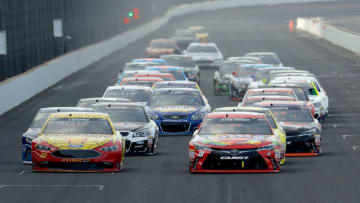INDIANAPOLIS, IN - JULY 24: Kyle Busch, driver of the #18 Skittles Toyota, races Joey Logano, driver of the #22 Shell Pennzoil Ford, during the NASCAR Sprint Cup Series Crown Royal Presents the Combat Wounded Coalition 400 at Indianapolis Motor Speedway on July 24, 2016 in Indianapolis, Indiana. (Photo by Andy Lyons/Getty Images)