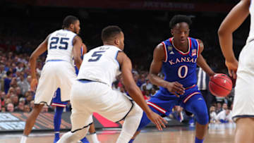 SAN ANTONIO, TX - MARCH 31: Marcus Garrett #0 of the Kansas Jayhawks is defended by Phil Booth #5 of the Villanova Wildcats in the first half during the 2018 NCAA Men's Final Four Semifinal at the Alamodome on March 31, 2018 in San Antonio, Texas. (Photo by Tom Pennington/Getty Images)
