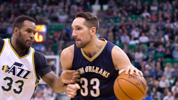 Dec 16, 2015; Salt Lake City, UT, USA; New Orleans Pelicans forward Ryan Anderson (33) dribbles the ball as Utah Jazz forward Trevor Booker (33) defends during the first half at Vivint Smart Home Arena. Mandatory Credit: Russ Isabella-USA TODAY Sports