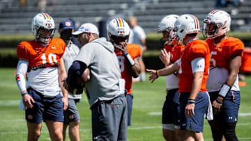 Auburn offensive coordinator Mike Bobo talks with the quarterbacks during an open football practice at Jordan-Hare Stadium in Auburn, Ala., on Saturday, March 20, 2021.