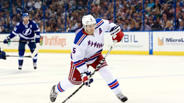 Nov 19, 2015; Tampa, FL, USA; New York Rangers defenseman Dan Girardi (5) shoots the puck against the Tampa Bay Lightning during the third period at Amalie Arena. Tampa Bay Lightning defeated the New York Rangers 2-1. Mandatory Credit: Kim Klement-USA TODAY Sports