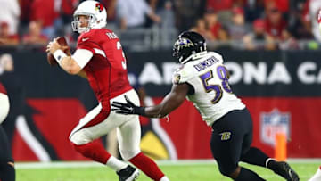Oct 26, 2015; Glendale, AZ, USA; Baltimore Ravens linebacker Elvis Dumervil (58) pursues Arizona Cardinals quarterback Carson Palmer (3) at University of Phoenix Stadium. The Cardinals defeated the Ravens 26-18. Mandatory Credit: Mark J. Rebilas-USA TODAY Sports