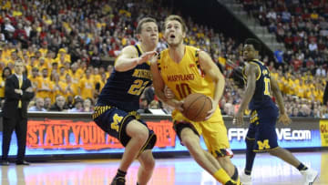 Feb 21, 2016; College Park, MD, USA; Maryland Terrapins forward Jake Layman (10) prepares to shoot the ball as Michigan Wolverines guard Duncan Robinson (22) defends during the second half at Xfinity Center. The Terrapins won 86-82. Mandatory Credit: Tommy Gilligan-USA TODAY Sports