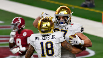 ARLINGTON, TEXAS - JANUARY 01: Joe Wilkins Jr. #18 of the Notre Dame Fighting Irish and Michael Mayer #87 celebrates during the College Football Playoff Semifinal at the Rose Bowl football game against the Alabama Crimson Tide at AT&T Stadium on January 01, 2021 in Arlington, Texas. The Alabama Crimson Tide defeated the Notre Dame Fighting Irish 31-14. (Photo by Alika Jenner/Getty Images)