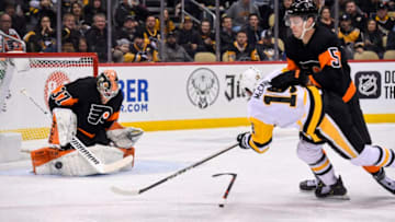 PITTSBURGH, PA - JANUARY 31: Philadelphia Flyers Goalie Brian Elliott (37) makes a save on Pittsburgh Penguins Left Wing Jared McCann (19) while Philadelphia Flyers Defenseman Philippe Myers (5) defends during the second period in the NHL game between the Pittsburgh Penguins and the Philadelphia Flyers on January 31, 2020, at PPG Paints Arena in Pittsburgh, PA. (Photo by Jeanine Leech/Icon Sportswire via Getty Images)