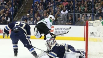 Dec 29, 2015; Columbus, OH, USA; Dallas Stars left wing Jamie Benn (14) collides with Columbus Blue Jackets goalie Curtis McElhinney (30) as he attempts a shot in the first period at Nationwide Arena. Mandatory Credit: Aaron Doster-USA TODAY Sports