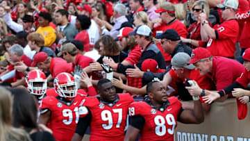 Nov 28, 2015; Atlanta, GA, USA; Georgia Bulldogs defensive end Josh Dawson (91), defensive lineman John Atkins (97) and defensive tackle James DeLoach (89) celebrates with fans after their game against the Georgia Tech Yellow Jackets at Bobby Dodd Stadium. The Bulldogs won 13-7. Mandatory Credit: Jason Getz-USA TODAY Sports