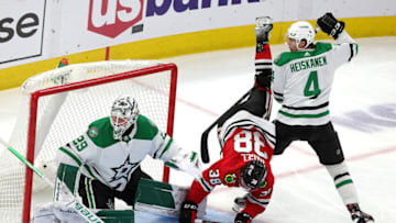 CHICAGO, ILLINOIS - FEBRUARY 18: Brandon Hagel #38 of the Chicago Blackhawks is tripped up by Miro Heiskanen #4 of the Dallas Stars during the third period at United Center on February 18, 2022 in Chicago, Illinois. Dallas defeated Chicago 1-0. (Photo by Stacy Revere/Getty Images)