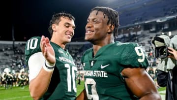 Michigan State's Payton Thorne, left, and Kenneth Walker III celebrate after beating Western Kentucky on Saturday, Oct. 2, 2021, at Spartan Stadium in East Lansing.211002 Msu Wku Fb 225a
