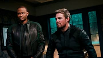 Arrow -- "Welcome to Hong Kong" -- Image Number: AR802a_0422b.jpg -- Pictured (L-R): David Ramsey as John Diggle/Spartan and Stephen Amell as Oliver Queen/Green Arrow -- Photo: Sergei Bachlakov/The CW -- © 2019 The CW Network, LLC. All Rights Reserved.