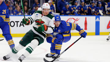 Nov 10, 2023; Buffalo, New York, USA; Minnesota Wild left wing Matt Boldy (12) looks to play the puck as Buffalo Sabres defenseman Henri Jokiharju (10) defends during the third period at KeyBank Center. Mandatory Credit: Timothy T. Ludwig-USA TODAY Sports
