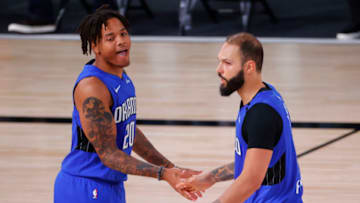 LAKE BUENA VISTA, FLORIDA - AUGUST 29: Evan Fournier #10 celebrates with Markelle Fultz #20 of the Orlando Magic after shooting a three point basket against the Milwaukee Bucks during the fourth quarter in Game Five of the Eastern Conference First Round during the 2020 NBA Playoffs at AdventHealth Arena at ESPN Wide World Of Sports Complex on August 29, 2020 in Lake Buena Vista, Florida. NOTE TO USER: User expressly acknowledges and agrees that, by downloading and or using this photograph, User is consenting to the terms and conditions of the Getty Images License Agreement. (Photo by Kevin C. Cox/Getty Images)