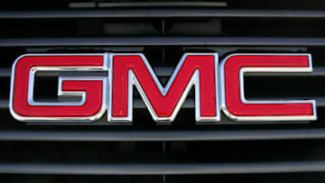 BURLINGAME, CA - OCTOBER 17: The GMC logo is seen on a SUV grill at an automotive sales lot October 17, 2005 in Burlingame, California. GM reported third quarter losses of $1.6 billion citing slow sales of SUVs due to the rising fuel prices. (Photo by Justin Sullivan/Getty Images)