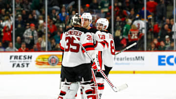 ST. PAUL, MN - NOVEMBER 20: New Jersey Devils goalie Cory Schneider (35) is congratulated by defenseman Ben Lovejoy (12) and defenseman Will Butcher (8) after the Devils scored in overtime during the regular season game between the New Jersey Devils and the Minnesota Wild on November 20, 2017 at Xcel Energy Center in St. Paul, Minnesota. The Devils defeated the Wild 4-3 in overtime. (Photo by David Berding/Icon Sportswire via Getty Images)