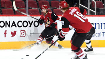 GLENDALE, ARIZONA - JANUARY 30: Conor Garland #83 of the Arizona Coyotes passes the puck to teammate Christian Dvorak #18 of the Coyotes during the first period of the NHL hockey game against the Los Angeles Kings at Gila River Arena on January 30, 2020 in Glendale, Arizona. (Photo by Norm Hall/NHLI via Getty Images)
