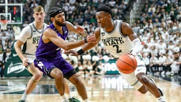 Michigan State's Tyson Walker, right, moves the ball as Northwestern Boo Buie defends during the first half on Sunday, Dec. 4, 2022, in East Lansing.221204 Msu Northwestern Bball 097a
