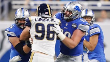 DETROIT, MI - OCTOBER 16: Travis Swanson #64 of the Detroit Lions and Graham Glasgow #60 double team Matt Longacre #96 of the Los Angeles Rams as he rushes quarterback Matthew Stafford #9 during second half at Ford Field on October 16, 2016 in Detroit, Michigan. Detroit Lions defeated the Los Angeles Rams 31-28. (Photo by Leon Halip/Getty Images)