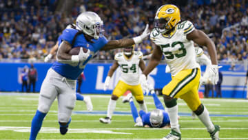 Jan 9, 2022; Detroit, Michigan, USA; Detroit Lions running back Jamaal Williams (30) stiff arms Green Bay Packers linebacker Jonathan Garvin (53) during the fourth quarter at Ford Field. Mandatory Credit: Raj Mehta-USA TODAY Sports