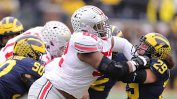 ANN ARBOR, MI - NOVEMBER 30: Wyatt Davis #52 of the Ohio State Buckeyes battles with Jordan Glasgow #29 of the Michigan Wolverines during the first quarter of the game at Michigan Stadium on November 30, 2019 in Ann Arbor, Michigan. Ohio State defeated Michigan 56-27. (Photo by Leon Halip/Getty Images)
