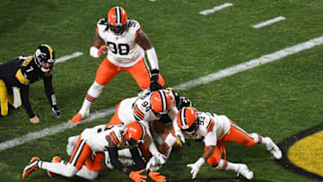 PITTSBURGH, PENNSYLVANIA - JANUARY 10: Karl Joseph #42, B.J. Goodson #93 and Adrian Clayborn #94 of the Cleveland Browns dive for a loose ball during the first half of the AFC Wild Card Playoff game against the Pittsburgh Steelers at Heinz Field on January 10, 2021 in Pittsburgh, Pennsylvania. (Photo by Joe Sargent/Getty Images)