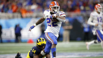 ATLANTA, GEORGIA - DECEMBER 29: Lamical Perine #22 of the Florida Gators escapes the tackle attempt of Josh Metellus #14 of the Michigan Wolverines and runs for a fourth quarter touchdown during the Chick-fil-A Peach Bowl at Mercedes-Benz Stadium on December 29, 2018 in Atlanta, Georgia. (Photo by Joe Robbins/Getty Images)