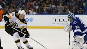 Mar 8, 2016; Tampa, FL, USA; Boston Bruins left wing Brad Marchand (63) shoots on goal as Tampa Bay Lightning goalie Ben Bishop (30) makes a save during the first period at Amalie Arena. Mandatory Credit: Kim Klement-USA TODAY Sports