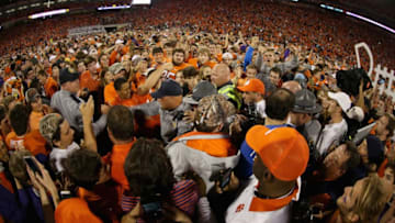 CLEMSON, SC - NOVEMBER 07: Head coach Dabo Swinney of the Clemson Tigers celebrates with fans after defeating the Florida State Seminoles 23-13 at Memorial Stadium on November 7, 2015 in Clemson, South Carolina. (Photo by Streeter Lecka/Getty Images)