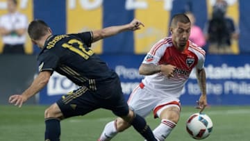 Jul 9, 2016; Philadelphia, PA, USA; D.C. United midfielder Luciano Acosta (11) controls the ball past Philadelphia Union defender Keegan Rosenberry (12) during the second half at Talen Energy Stadium. The Philadelphia Union won 3-0. Mandatory Credit: Bill Streicher-USA TODAY Sports