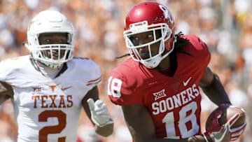 Oct 8, 2016; Dallas, TX, USA; Oklahoma Sooners wide receiver Dahu Green (18) runs after catching a pass against Texas Longhorns cornerback Kris Boyd (2) in the third quarter at Cotton Bowl. Oklahoma won 45-40. Mandatory Credit: Tim Heitman-USA TODAY Sports