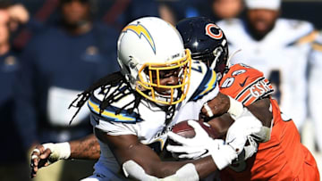 CHICAGO, ILLINOIS - OCTOBER 27: Melvin Gordon #25 of the Los Angeles Chargers is brought down by Danny Trevathan #59 of the Chicago Bears during the second half of a game at Soldier Field on October 27, 2019 in Chicago, Illinois. (Photo by Stacy Revere/Getty Images)