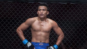 PHNOM PENH, CAMBODIA - SEPTEMBER 12: Chan Rothana stands by the cage while doctors examine his opponent Sam And Dun during One FC Cambodia on September 12, 2014 in Phnom Penh, Cambodia. (Photo by Omar Havana/Getty Images)
