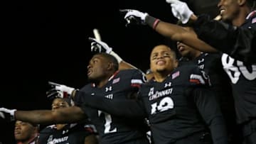 Nov 14, 2015; Cincinnati, OH, USA; Cincinnati Bearcats wide receiver Shaq Washington (R) stands with wide receiver Mekale McKay (2) and teammates after their game against the Tulsa Golden Hurricane at Nippert Stadium. The Bearcats won 49-38. Mandatory Credit: Aaron Doster-USA TODAY Sports