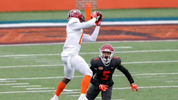 MOBILE, AL - JANUARY 30: Wide Receiver Shi Smith #13 from South Carolina of the American Team makes a catch over Safety Tre Norwood #5 from Oklahoma of the National Team during the 2021 Resse's Senior Bowl at Hancock Whitney Stadium on the campus of the University of South Alabama on January 30, 2021 in Mobile, Alabama. The National Team defeated the American Team 27-24. (Photo by Don Juan Moore/Getty Images)