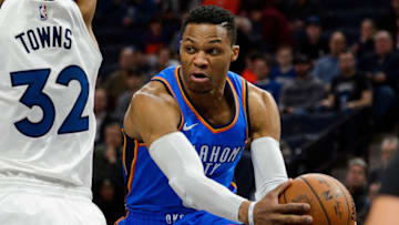MINNEAPOLIS, MN - JANUARY 10: Russell Westbrook #0 of the Oklahoma City Thunder passes the ball around Karl-Anthony Towns #32 of the Minnesota Timberwolves. (Photo by Hannah Foslien/Getty Images)