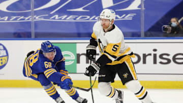 Apr 17, 2021; Buffalo, New York, USA; Buffalo Sabres right wing Victor Olofsson (68) reaches to try and knock the puck off the stick of Pittsburgh Penguins defenseman Zach Trotman (5) during the second period at KeyBank Center. Mandatory Credit: Timothy T. Ludwig-USA TODAY Sports