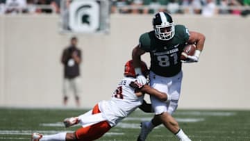 EAST LANSING, MI - SEPTEMBER 02: Matt Sokol #81 of the Michigan State Spartans tries to escape the tackle of Cameron Jefferies #18 of the Bowling Green Falcons at Spartan Stadium on September 2, 2017 in East Lansing, Michigan. Michigan State won the game 35-10. (Photo by Gregory Shamus/Getty Images)