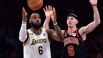 Mar 26, 2023; Los Angeles, California, USA; dLos Angeles Lakers forward LeBron James (6) plays for the ball against Chicago Bulls guard Alex Caruso (6) uring the first half at Crypto.com Arena. Mandatory Credit: Gary A. Vasquez-USA TODAY Sports