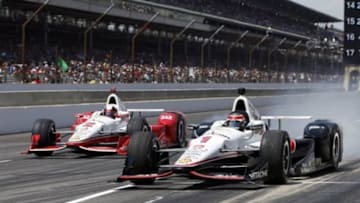 May 24, 2015; Indianapolis, IN, USA; IndyCar Series driver Will Power (1) completes a pit stop next to Juan Pablo Montoya (2) during the 2015 Indianapolis 500 at Indianapolis Motor Speedway. Mandatory Credit: Brian Spurlock-USA TODAY Sports