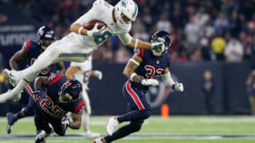 HOUSTON, TX - OCTOBER 25: Mike Gesicki #86 of the Miami Dolphins is tackled by Kareem Jackson #25 of the Houston Texans in the second quarter at NRG Stadium on October 25, 2018 in Houston, Texas. (Photo by Tim Warner/Getty Images)