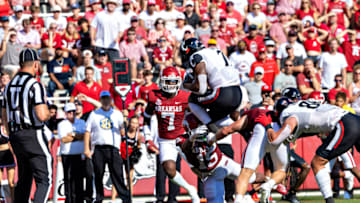 Corey Kiner of the Cincinnati Bearcats jumps into the end zone for a touchdown against the Arkansas Razorbacks. Getty Images.