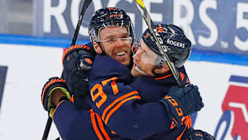 May 8, 2021; Edmonton, Alberta, CAN; Edmonton Oilers forward Connor McDavid (97) celebrates his 100th point of the season on a goal by forward Leon Draisaitl (29) against the Vancouver Canucks at Rogers Place. Mandatory Credit: Perry Nelson-USA TODAY Sports