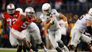 Jan 12, 2015; Arlington, TX, USA; Oregon Ducks quarterback Marcus Mariota (8) scrambles against the Ohio State Buckeyes in the 2015 CFP National Championship Game at AT&T Stadium. Mandatory Credit: Matthew Emmons-USA TODAY Sports