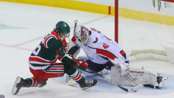 Apr 2, 2021; Newark, New Jersey, USA; Washington Capitals goaltender Vitek Vanecek (41) makes a save on New Jersey Devils center Jack Hughes (86) during overtime at Prudential Center. Mandatory Credit: Ed Mulholland-USA TODAY Sports