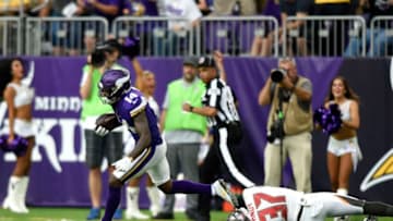 MINNEAPOLIS, MN - SEPTEMBER 24: Stefon Diggs #14 of the Minnesota Vikings breaks a tackle by defender Keith Tandy #37 of the Tampa Bay Buccaneers and runs with the ball for a touchdown in the second half of the game on September 24, 2017 at U.S. Bank Stadium in Minneapolis, Minnesota. (Photo by Hannah Foslien/Getty Images)