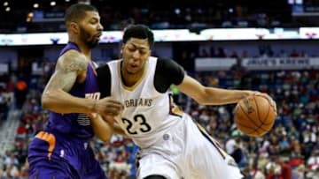 Apr 10, 2015; New Orleans, LA, USA; New Orleans Pelicans forward Anthony Davis (23) dribbles the ball as Phoenix Suns forward Markieff Morris (11) defends during the first quarter of a game at the Smoothie King Center. Mandatory Credit: Derick E. Hingle-USA TODAY Sports